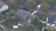 Crane moving hot tub topples over onto home