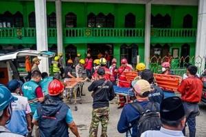 Two pulled from Indonesia school collapse as rescuers race against time