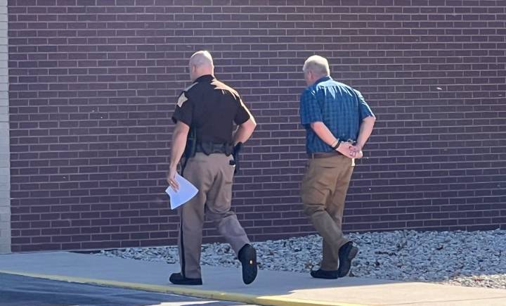 Johnson County coroner turns himself in to police after being charged with buying alcohol for a high schooler