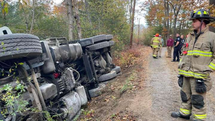 Driver rescued after dump truck rolls over in York