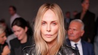Charlize Theron opts for nothing under her leather biker jacket for bold fashion week appearance