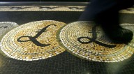 Sterling drops after UK data shows softer wage growth
