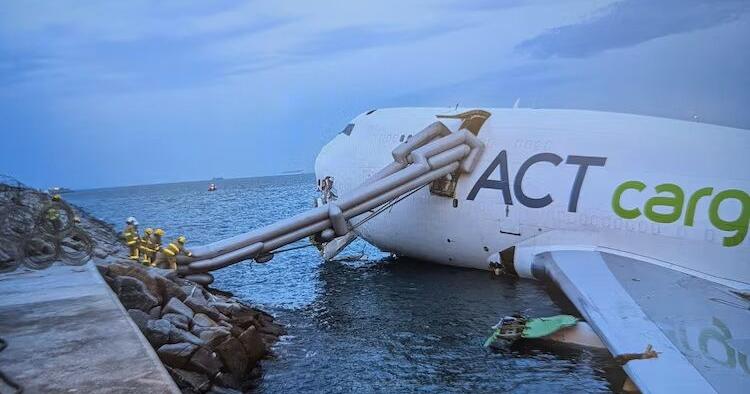 A cargo aircraft skids off a Hong Kong runway into the sea, killing 2 airport workers
