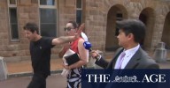Supporters lash out at cameras outside court