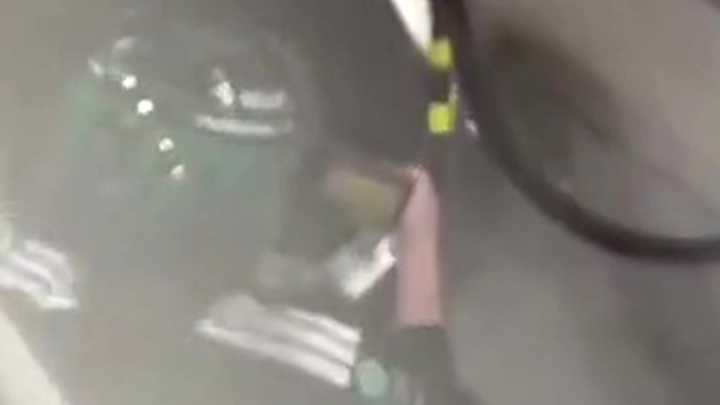 Formula 1 mechanic spotted watching Championship match during Singapore Grand Prix