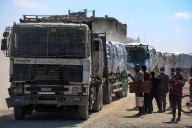 Aid Trucks Enter Gaza As Dispute Over Hostage Bodies Temporarily Paused