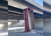 Dump truck bed hits bridge, closes lanes of S.R. 201
