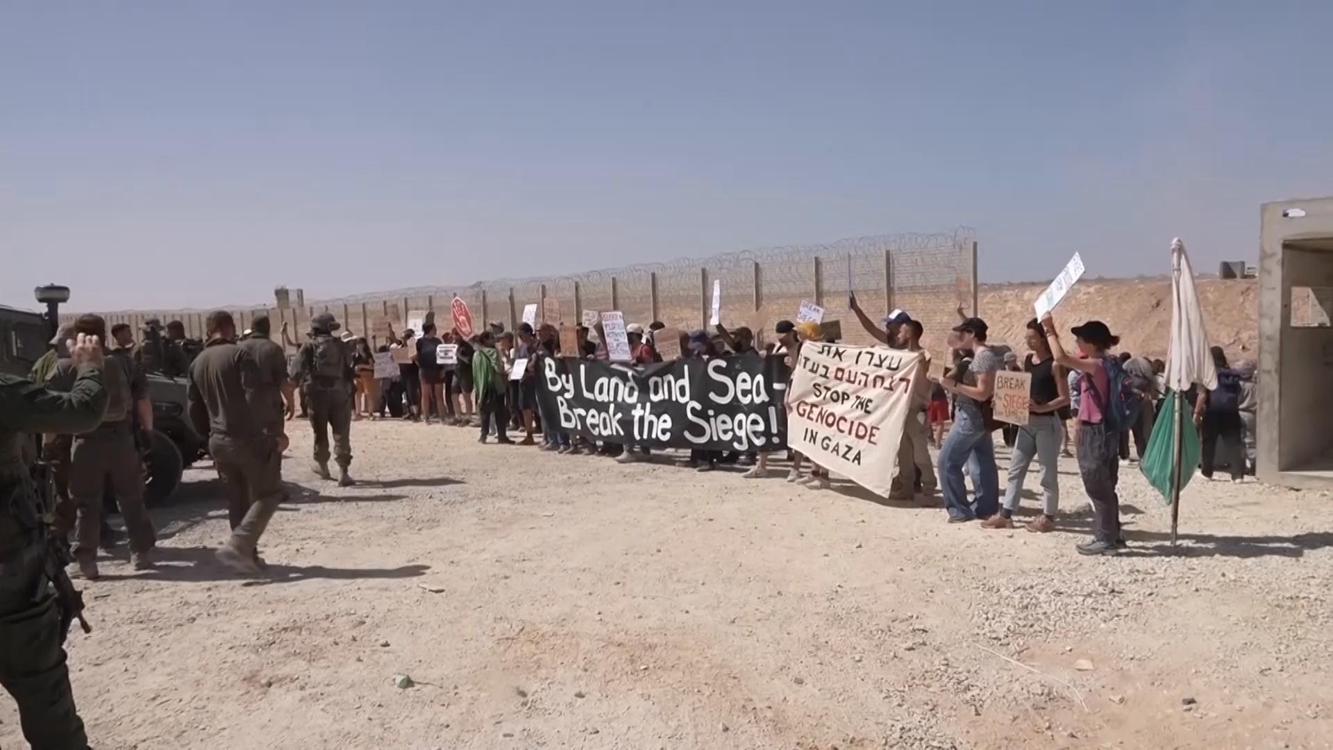 Israeli protesters block troops entering Gaza as they demand flotilla entry into enclave