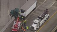 Semi-truck tractor dangles over freeway
