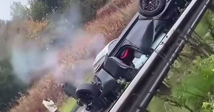 Horror pictures after car is smashed into road sign and flipped onto roof