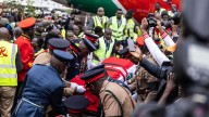 Kenya police fire at mourners and 2 die as violence erupts at viewing of body of ex