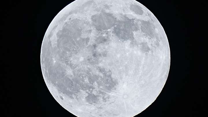 The Harvest moon rises over the Little San Bernardino Mountains