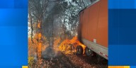 Driver uninjured after semi-truck veers off I-40, catches fire in woods, Rural Metro Fire says