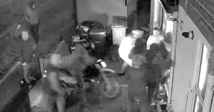 Horrifying moment 12 thugs storm a property after battering down door with motorbike
