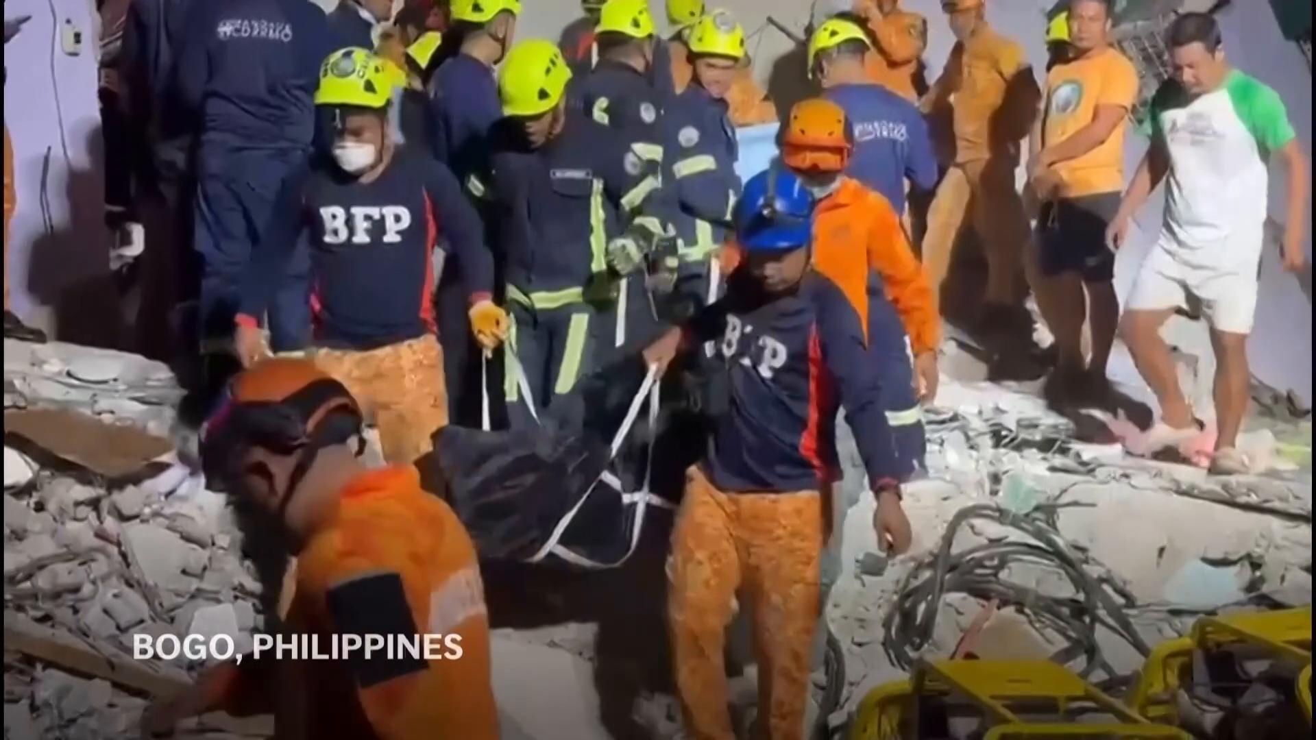 AP photographer describes the scene as workers retrieve bodies after Philippines earthquake