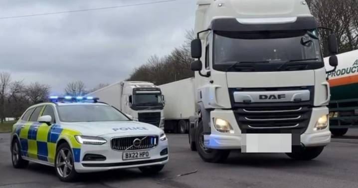Hungry HGV driver eats meal at the wheel in the Midlands