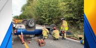Firefighters rescue driver from overturned truck carrying boxes of bees in Clark County