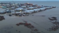 Officials airlift evacuees to safety after the remnants of Typhoon Halong devastate Alaska villages