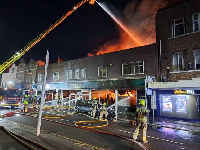 Huge fire above south east London shop sends smoke billowing into the sky