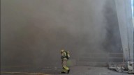 Diez dotaciones de bomberos trabajan en la extinción de un incendio en una nave en Sabadell