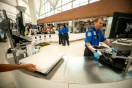The shutdown means TSA agents and air traffic controllers are working without pay at DIA