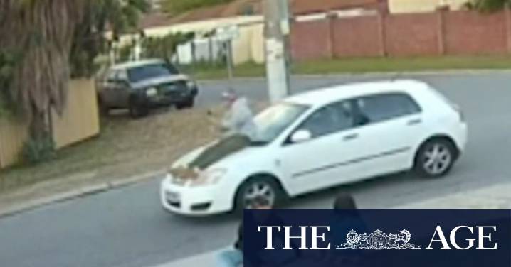 Passenger caught on camera riding on car bonnet