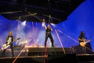 80s rocker known for notorious temper crashes out on stage, throws microphone at drum kit