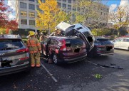 1 hospitalized after car lands on 2 vehicles in parking lot