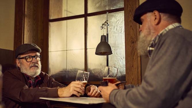 Old men in pub do not need words to express their love