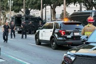 Man with sign referencing Trump barricades himself inside car outside Los Angeles City Hall