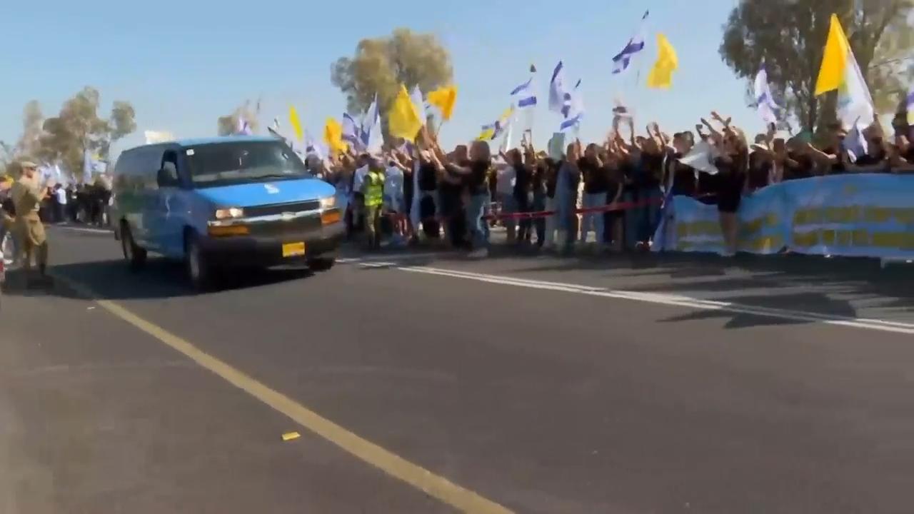 Convoy carrying released hostages escorted across border into southern Israel