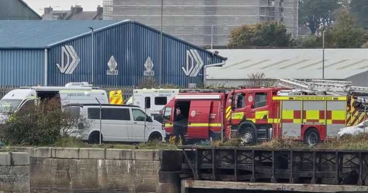 Coastguard and lifeboat crews rescue injured person after fall at docks