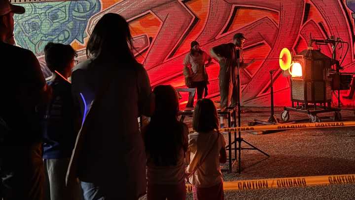 Night Glow illuminates the night sky behind Arts in The Sunset