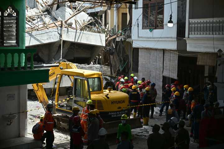 Survivors pulled from collapsed school in Indonesia