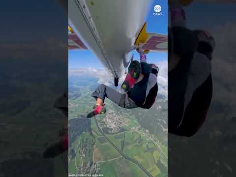 Climber scales exterior of glider in flight