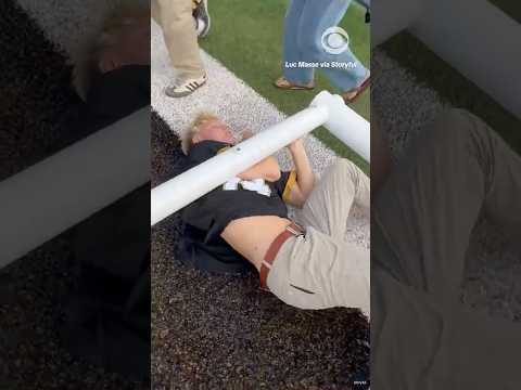 Man gets stuck under fallen football goal post after fans rush the field #shorts