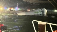 Two dead after cargo plane slides off runway into the sea in Hong Kong
