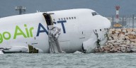 Two killed after cargo jet skids off Hong Kong runway, crashing into the sea