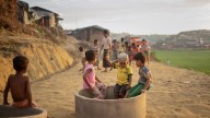 With makeshift jump ropes and hide and seek, kids play to cope with crisis