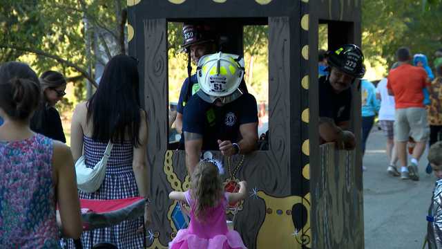 Real-life superheroes hand out candy at Boo at the Zoo firefighter night