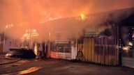 Two firefighters hospitalized after Harvey auto body shop fire