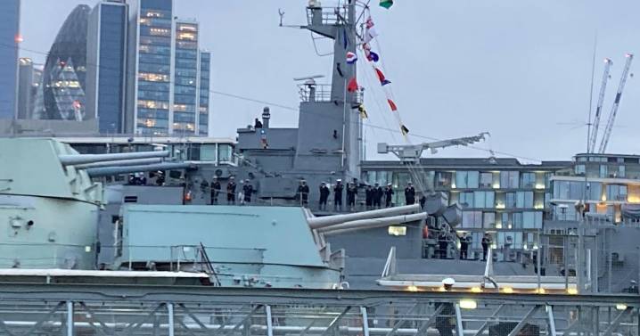 Watch as warship packed with sailors sails up Thames between Tower Bridge and London Bridge