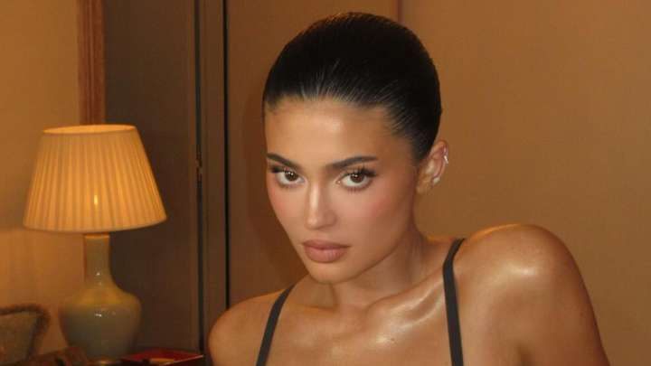 Kylie Jenner nearly busts out of tiny black bra and thong as she sips wine in Paris hotel room