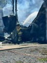 Shop destroyed after catching fire from nearby burn barrel