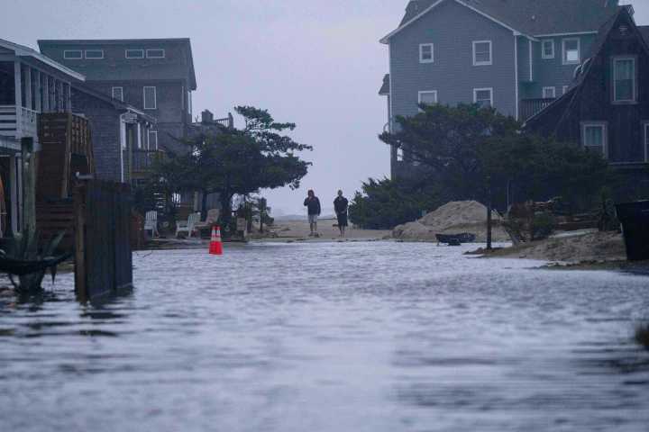 Dozens rescued as remnants of typhoon hits Alaska while nor'easter brings flooding to East Coast