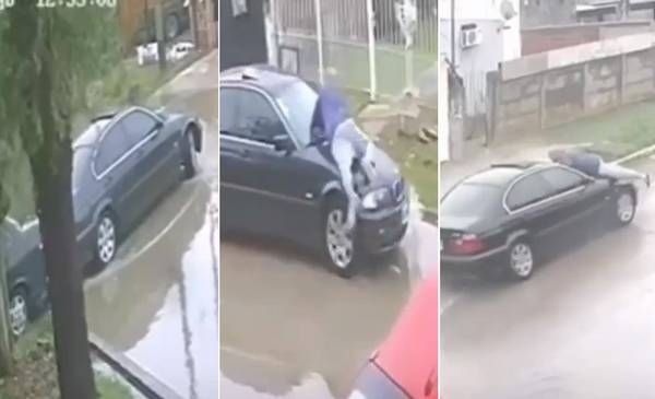VIDEO. Un BMW chocó a un auto estacionado en Berisso y arrastró arriba del capot al dueño