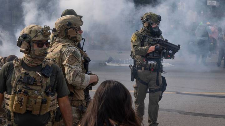 Trump deploys National Guard troops to Chicago as scores of protestors heatedly face off against federal immigration agents