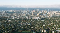 Aussie suburbs where one train stop makes houses over $1million cheaper