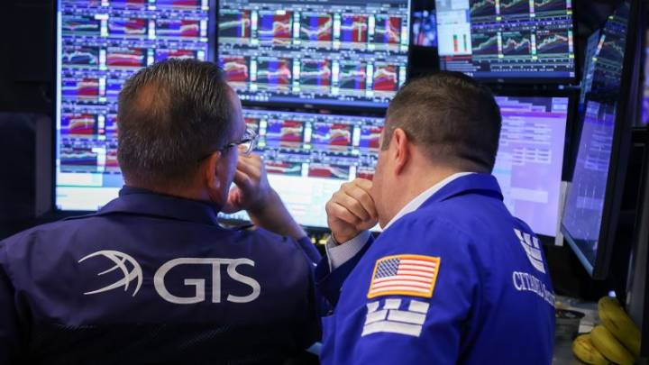 Stocks slide as government officially shuts down