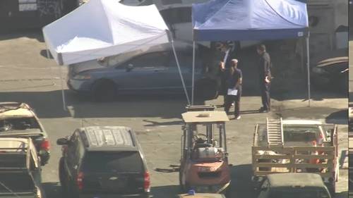 Woman arrested for murder after body found in car at South Los Angeles tow yard
